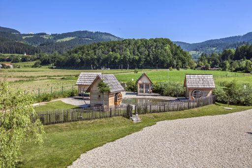 A high angle shot of small wooden houses in the countryside in Slovenia