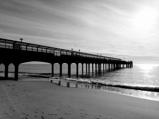 A grayscale shot of the beautiful Boscombe Pier on the shore