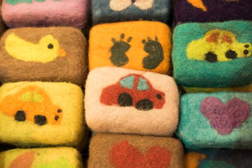 A high angle closeup shot of small fluffy toys with colorful pictures