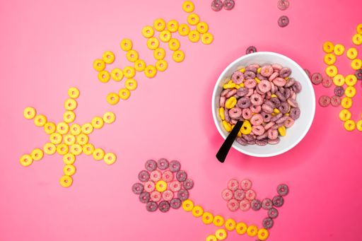 A closeup shot of a bowl with crunchy cereal next to the word sun