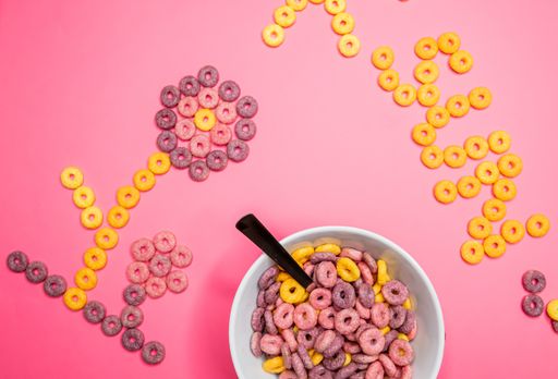A closeup shot of a bowl with crunchy cereal next to the word sun