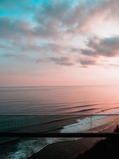 A mesmerizing view from the balcony, a cloudscape over the sea at sunset