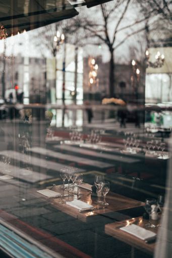 A vertical shot of a restaurant seen through the exterior win