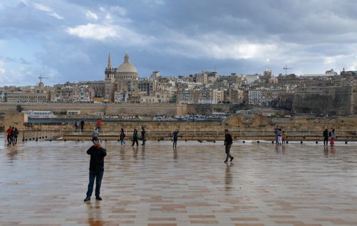 Seen from  Fort Manoel parade ground, Our lady of Mount Carmel church's prominent dome, the walls and buildings of Valletta, capital city of Malta