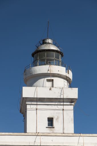 A low angle shot of a building under a blue sky at Capo Testa, Sardegna