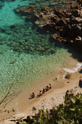 A vertical shot of the rocky coast of Capo Testa Lighthouse in Sardinia, Italy