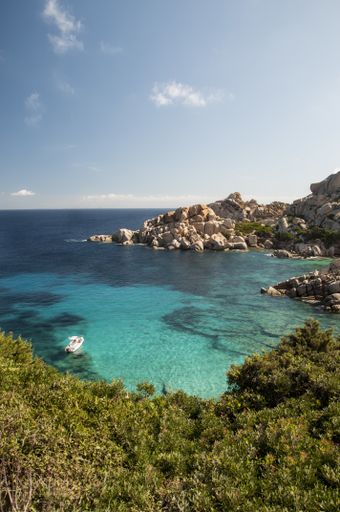 A vertical shot of the rocky coast of Capo Testa Lighthouse in Sardinia, Italy