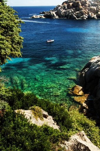 A vertical shot of the rocky coast of Capo Testa Lighthouse in Sardinia, Italy