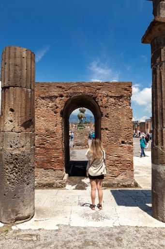 Tourist taking photos of ruins in Pompeii