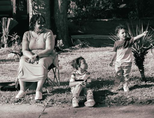 A mother with her two children in street in black and white