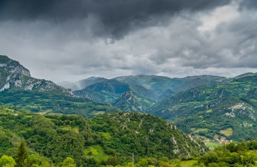 A beautiful mountainous landscape under a cloudy sky in Asturias, Spain