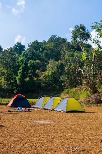A beautiful landscape of camp and tents with hills in the background at Arthur Lake in Bhandardara in Maharashtra, India