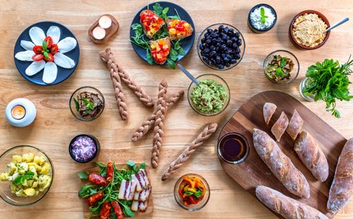 A close-up of an assortment of small bowls filled with various types of food