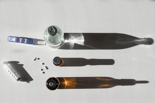 A top view of medicines and solution on white background