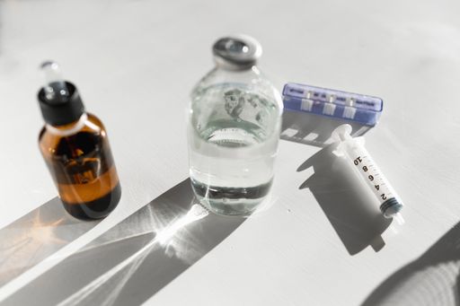 A closeup shot of syringe and medicals on a white background