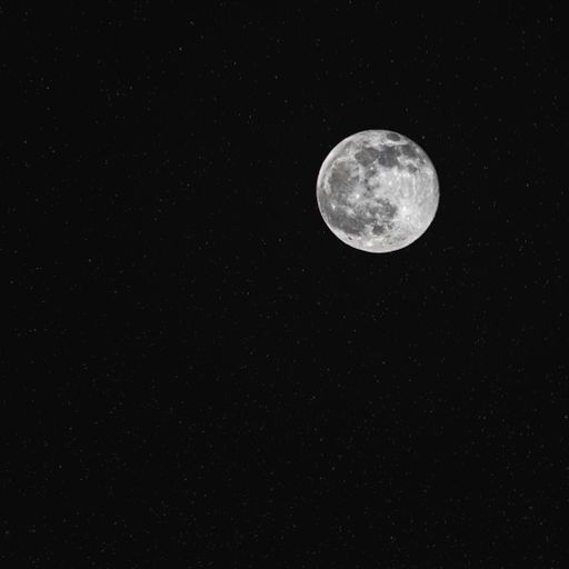 A breathtaking view of the full moon against a dark starry night sky