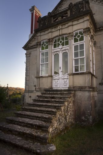A vertical shot of a vintage stone house on a gloomy day