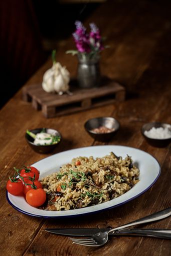 A vertical shot of a plate with rice and forest mushrooms