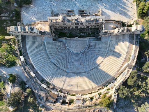 An aerial shot of the Odeon of Herodes Atticus stone Roman theatre structure in Athens, Greece.