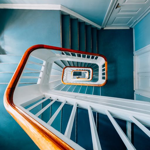 A high angle view of a modern spiral staircase in an exhibition under the lights