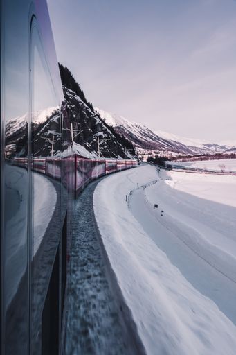 An exciting journey by a train moving through mountain terrain, beautiful winter view from the window
