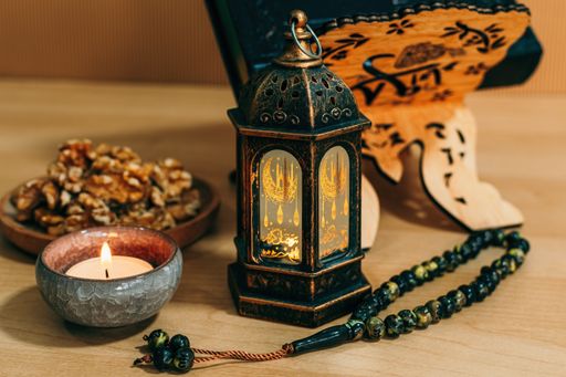 A closeup shot of trays with nuts and lanterns with candles