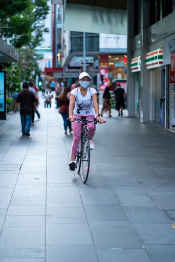 Singapore, February 2, 2021: Active woman cycling on Orchard road.