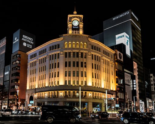 A beautiful view of Ginza Wako Clock Tower illuminated at night in Tokyo, Japan