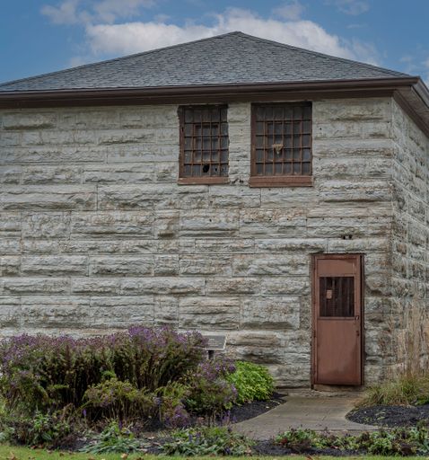 A vertical shot of an old stone building in the countryside