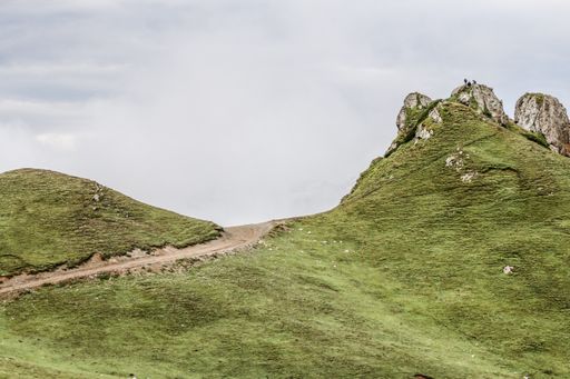 A view of a small trail on the grassy hill in Kumrat Valley, Pakistan against white sky background