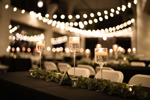 A classic Evening Wedding reception with candles and string bulb lights