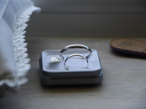 This is a stock photo of a couple of silver rings sitting on top of a box