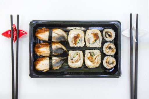 A top view shot of eel fish sushi rolls on an isolated white surface