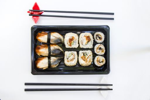 A top view shot of eel fish sushi rolls on an isolated white surface