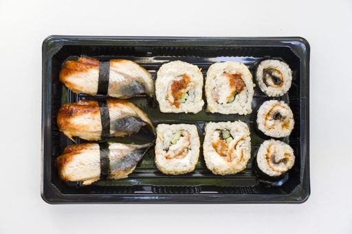 A top view shot of eel fish sushi rolls on an isolated white surface