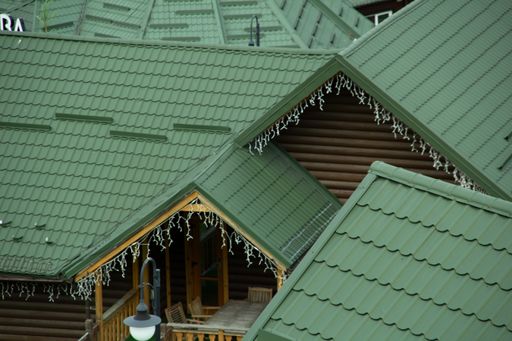 Modern house covering. Green roofs with metal tiles. Top view.
