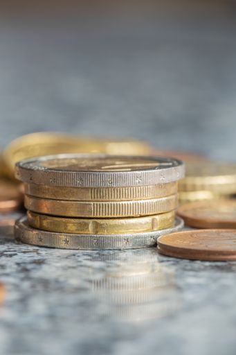 A selective focus shot of a stack of euro coins