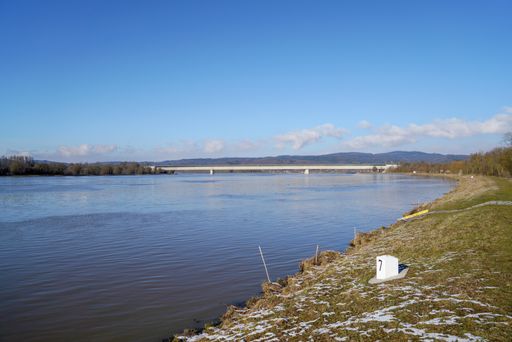 A river Danube under the blue clear sky and the bridge in the background