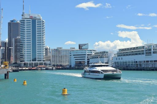 View of Fullers catamaran ferry leaving Auckland downtown terminal
