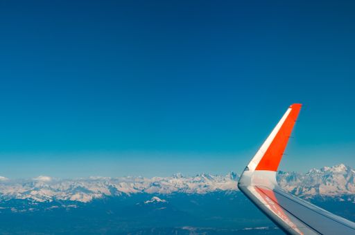 Aerial view of Mont Blanc and the entire Alps from an airliner, wing, and wingtip in view