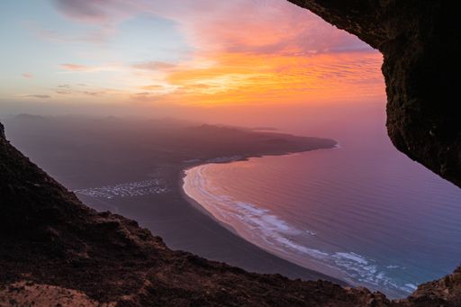 Beautiful sunset from cave in the cliffs of Famara. Lanzarote, Canary Islands, Spain. This place is famous for the weather conditions for water sports