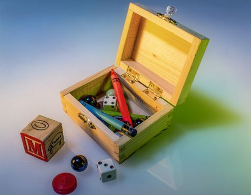 A closeup shot of a wooden box with different objects for children
