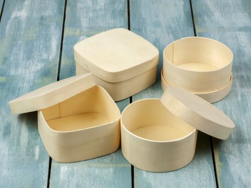 A closeup shot of beige empty gift boxes on wooden planks