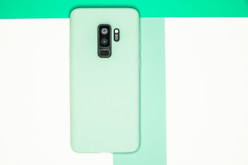 A top view of mobile phone case isolated on pastel colors background with copy space