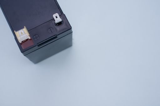 An overhead partial view of a UPS battery replacement cartridge on white surface with space for your text
