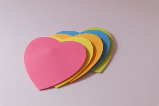 Colorful heart-shaped paper stickers on the table