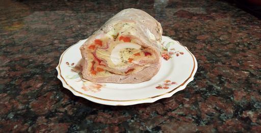 Matambre, classic Argentine rolled meat dish, stuffed with hard boiled eggs, vegetables, carrot, peppers, ham and herbs, and boiled. Selective focus.