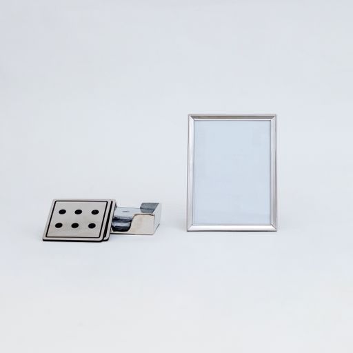 A closeup shot of domino cards and white picture frame with copy space