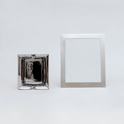 A closeup shot of alcohol flask and a picture frame with copy space