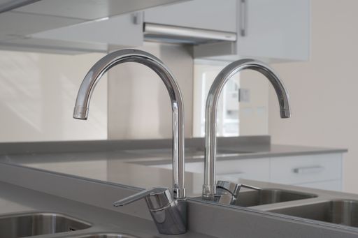 A closeup of a kitchen sink, the interiors of a modern house